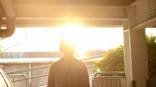 Man standing in sunlight indoors
