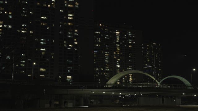 Nighttime View of Urban Bridge and Buildings