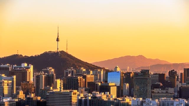 Changing skyline of a bustling city from dusk to night