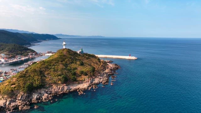 Lighthouse on a hill overlooking the sea