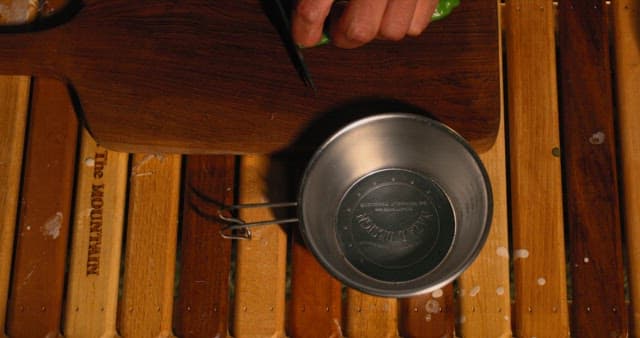 Cheongyang peppers being cut on a wooden cutting board