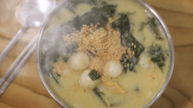 Bowl of warm glutinous rice dumplings with dried pollack and seaweed