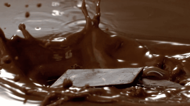 Chocolate pieces falling into chocolate fondue