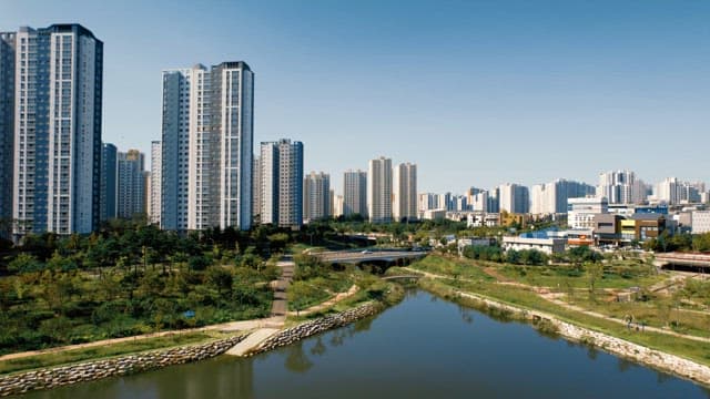 Landscape with high-rise apartments and river on a sunny day