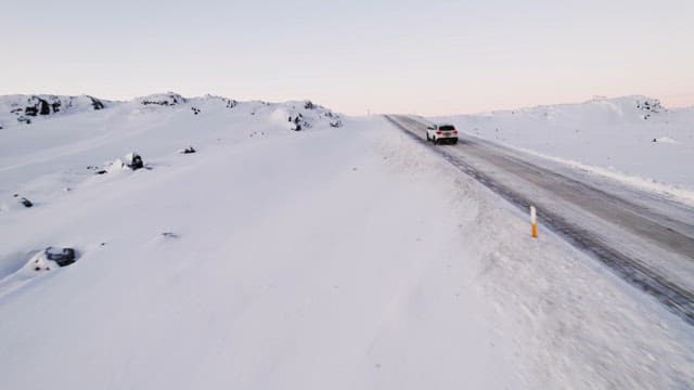 Car driving on a snowy mountain road