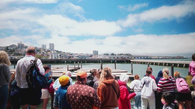 Group of Tourists Enjoying Waterfront View