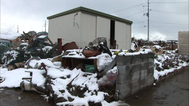 Collapsed houses and debris in a village swept away by the tsunami