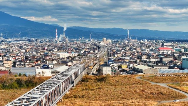 Cityscape with a train crossing a bridge