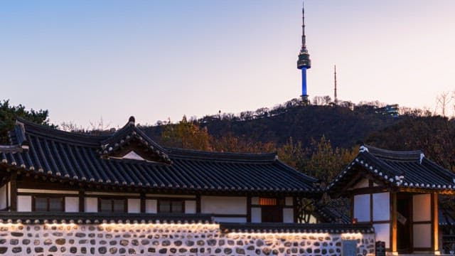 Traditional Korean houses with tower at sunset