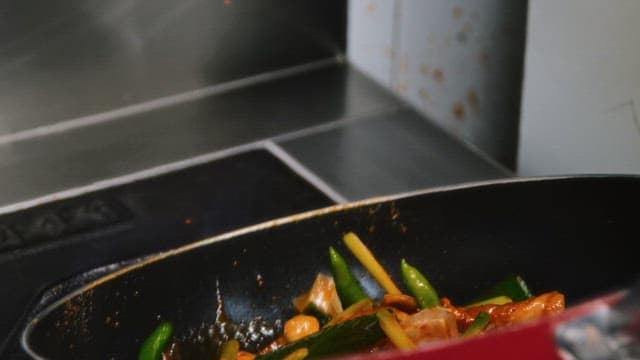 Cooking Chicken Stir Fry witn Pan on Stove