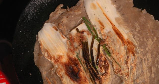 Preparing Vegetable Pancakes Outdoors at Night during Camping