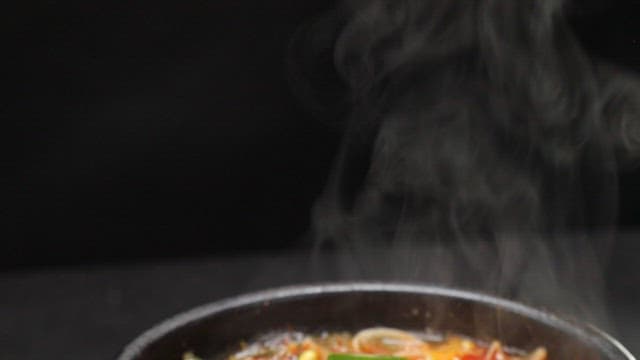 Steaming pot of spicy Korean beef and rice soup