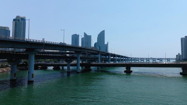 Busan cityscape with modern high-rise buildings, overpass, and yacht marina