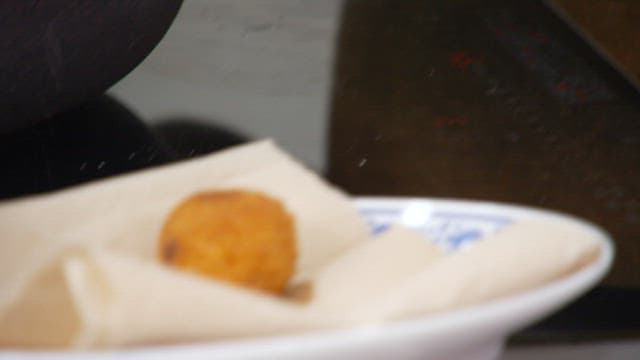 Crispy fried food plated on a napkin-lined plate