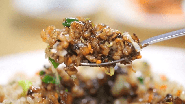 Spoonful of fried rice with vegetables and Jjajang sauce