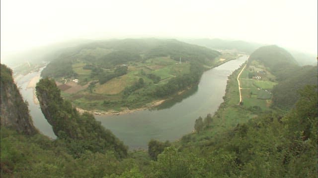 Aerial View of Serene Donggang River Meandering Through Lush Landscape