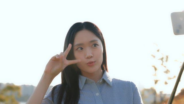 Woman taking a selfie in a park