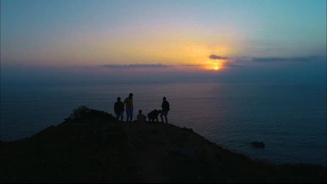Group Watching Sunrise by the Sea