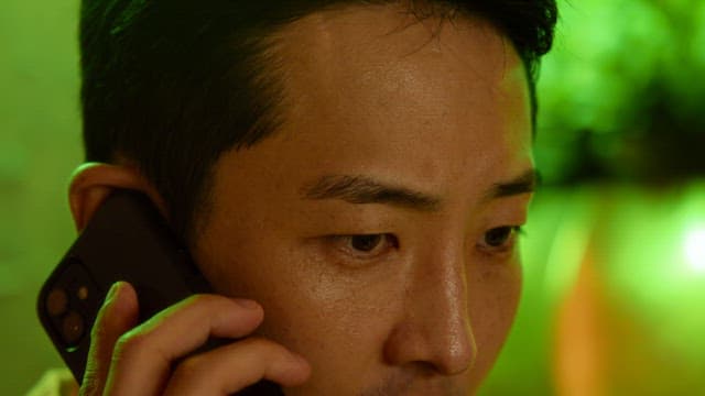 Man talking on the phone with a serious expression