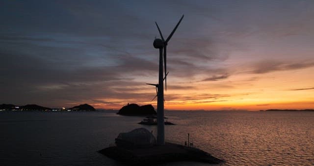 Wind Turbines at Sea During Sunset