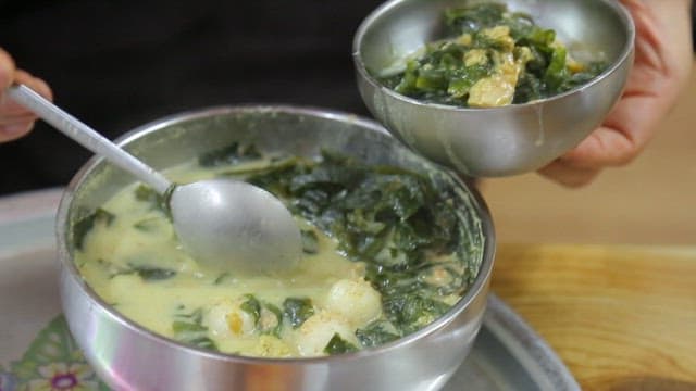Spoonful of warm glutinous rice dumplings with dried pollack and seaweed