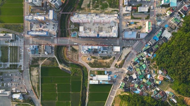 View of a city with green fields
