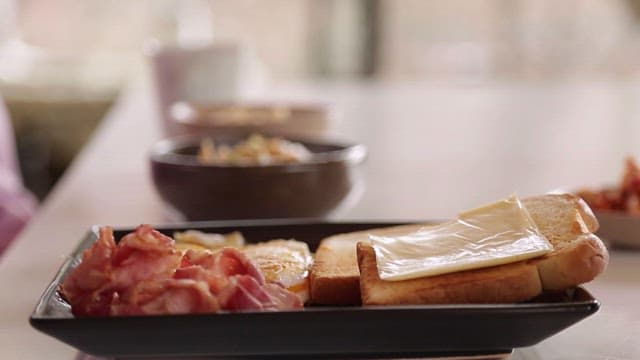 A breakfast plate with bacon, eggs, and toast