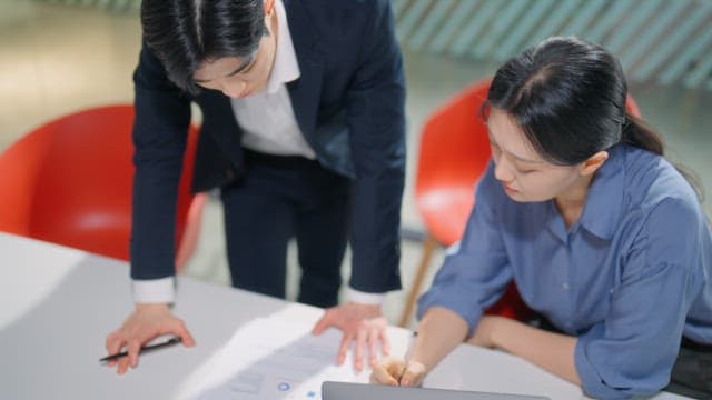People discussing documents at a table