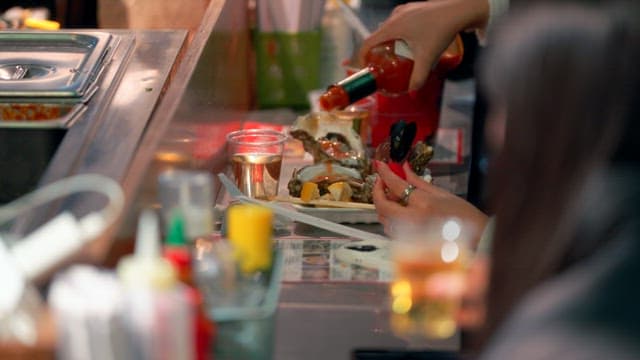People enjoying seafood at a street food stall