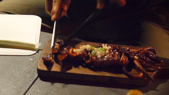 Grilled Squid Being Served at Night