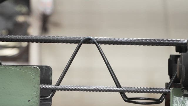 Metal rods being processed in a factory