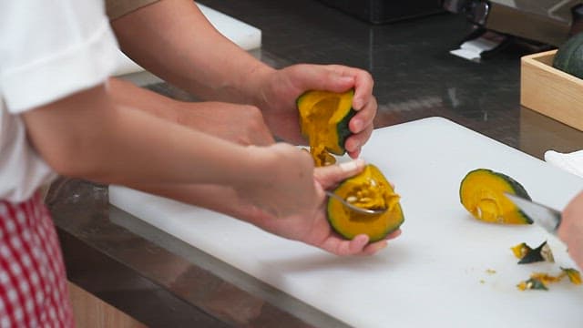 Chef Preparing Hollowed-out Pumpkin in the Kitchen
