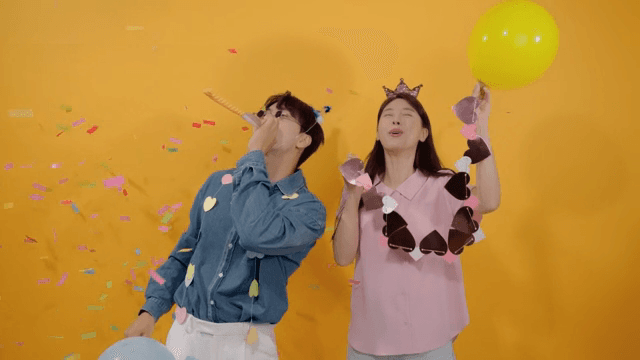 Two happy people celebrating with balloons