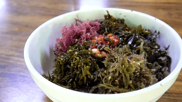 Preparing and mixing colorful vegetable bibimbap with Seaweed
