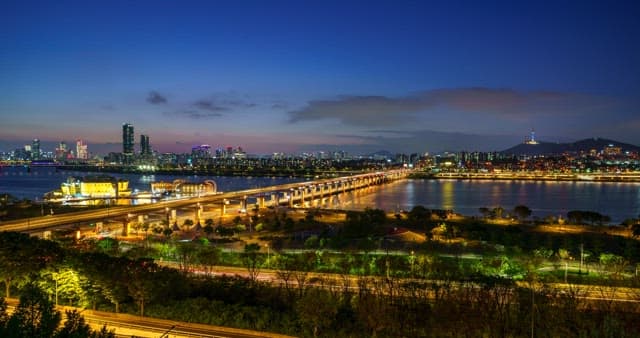 Seoul cityscape at night with Han River bridge