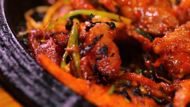 Appetizing and spicy grilled pork with seasoned deodeok