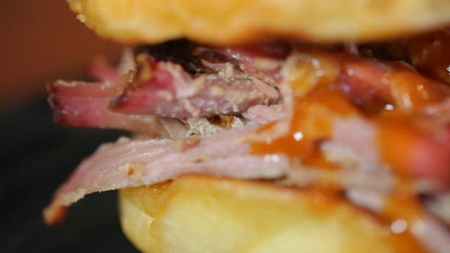 Juicy pulled pork sandwich with sauce