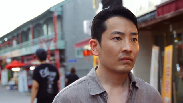 Man walking through a busy street market
