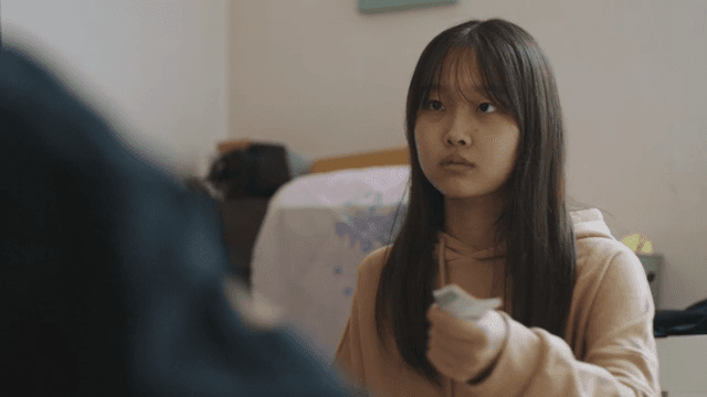 Girl receiving money from adult