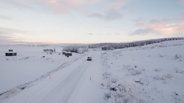 Car driving through a snowy landscape