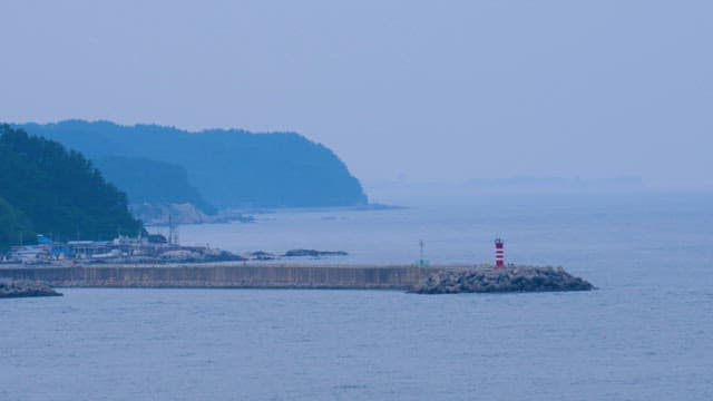 Calm Misty Morning View of a Coastal Lighthouse