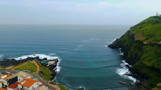 Clean waves crashing against the blue cliffs and coastline
