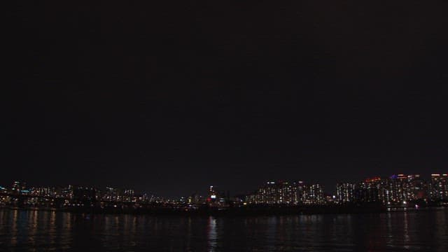 Colorful Fireworks Display Over the City Skyline and River