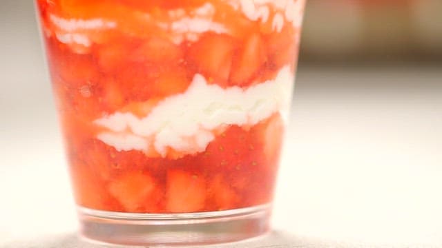 Layered cream strawberry dessert in a cup