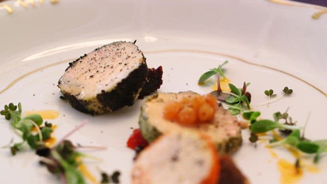 Plating of gourmet fish dish with garnish