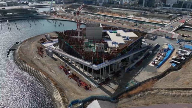 Large building under construction by the water