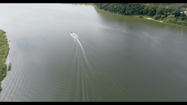 Boat cruising on a wide river