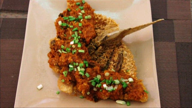 Fried Fish Topped with Sauce and Greens