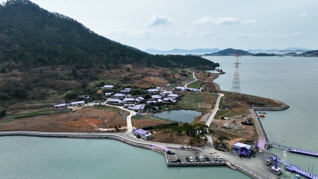 Scenic coastal village with purple roofs