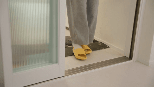 Changing slippers at the apartment entrance